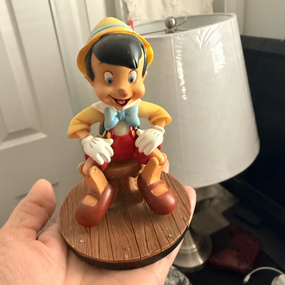 Pinocchio Figurine with Blue Bow and Yellow Hat